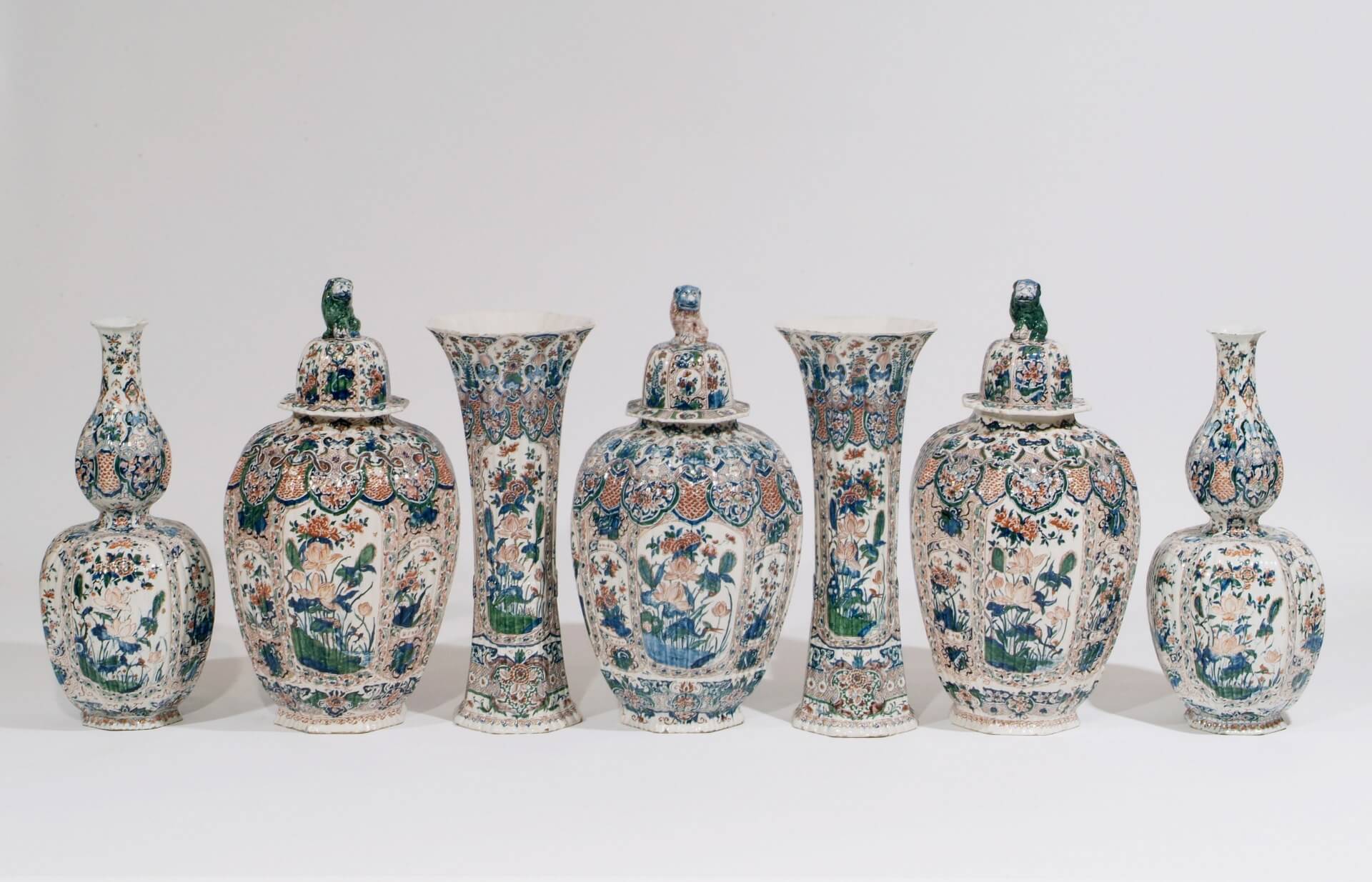 Garniture of polychrome vases antique Delft pottery