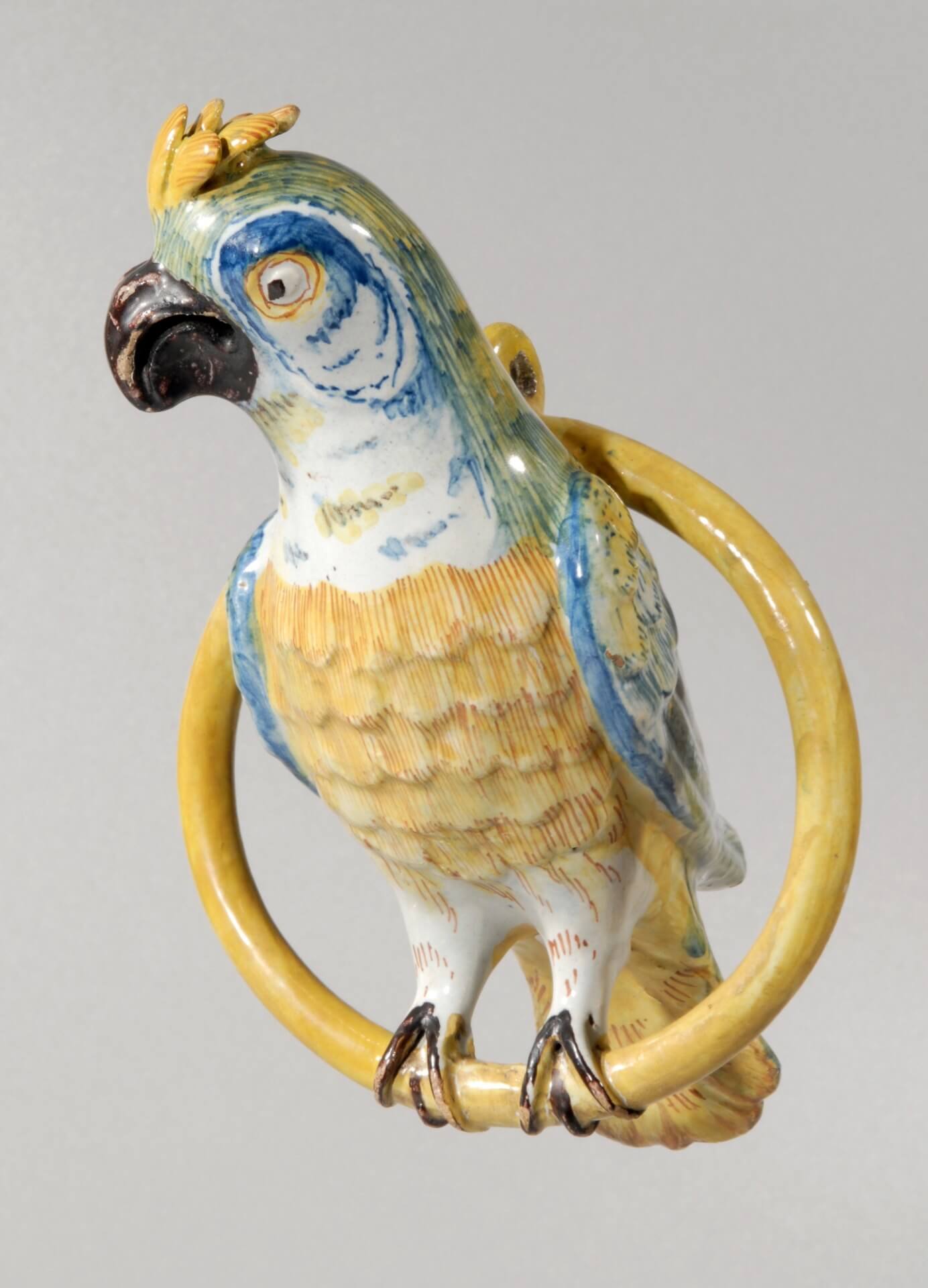 Antique polychrome figurine of parrot in ring