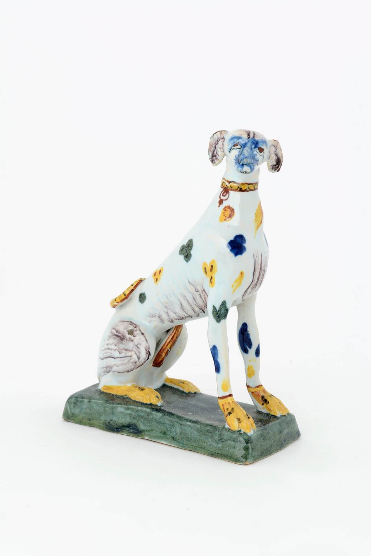 Antique polychrome ceramic of seated greyhound