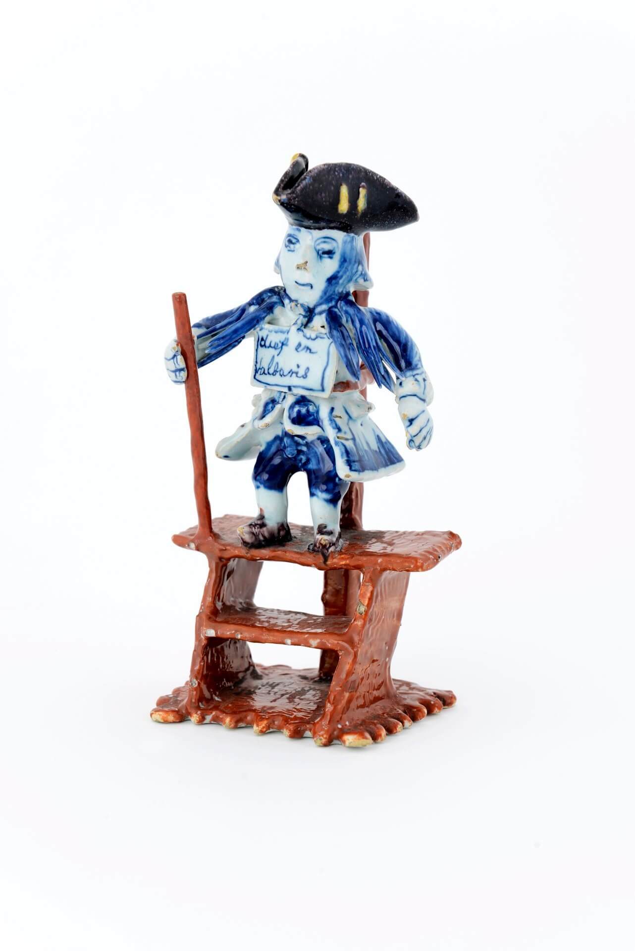 antique Delft pottery polychrome figure of a criminal