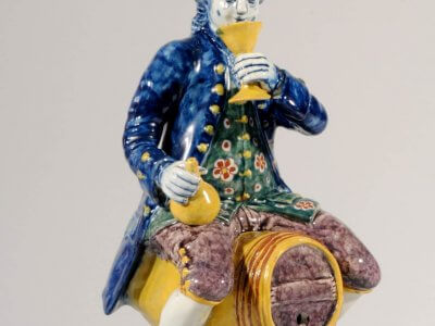 Antique Dutch Delft Pottery Of Man Sitting On Barrel In Polychrome Colours