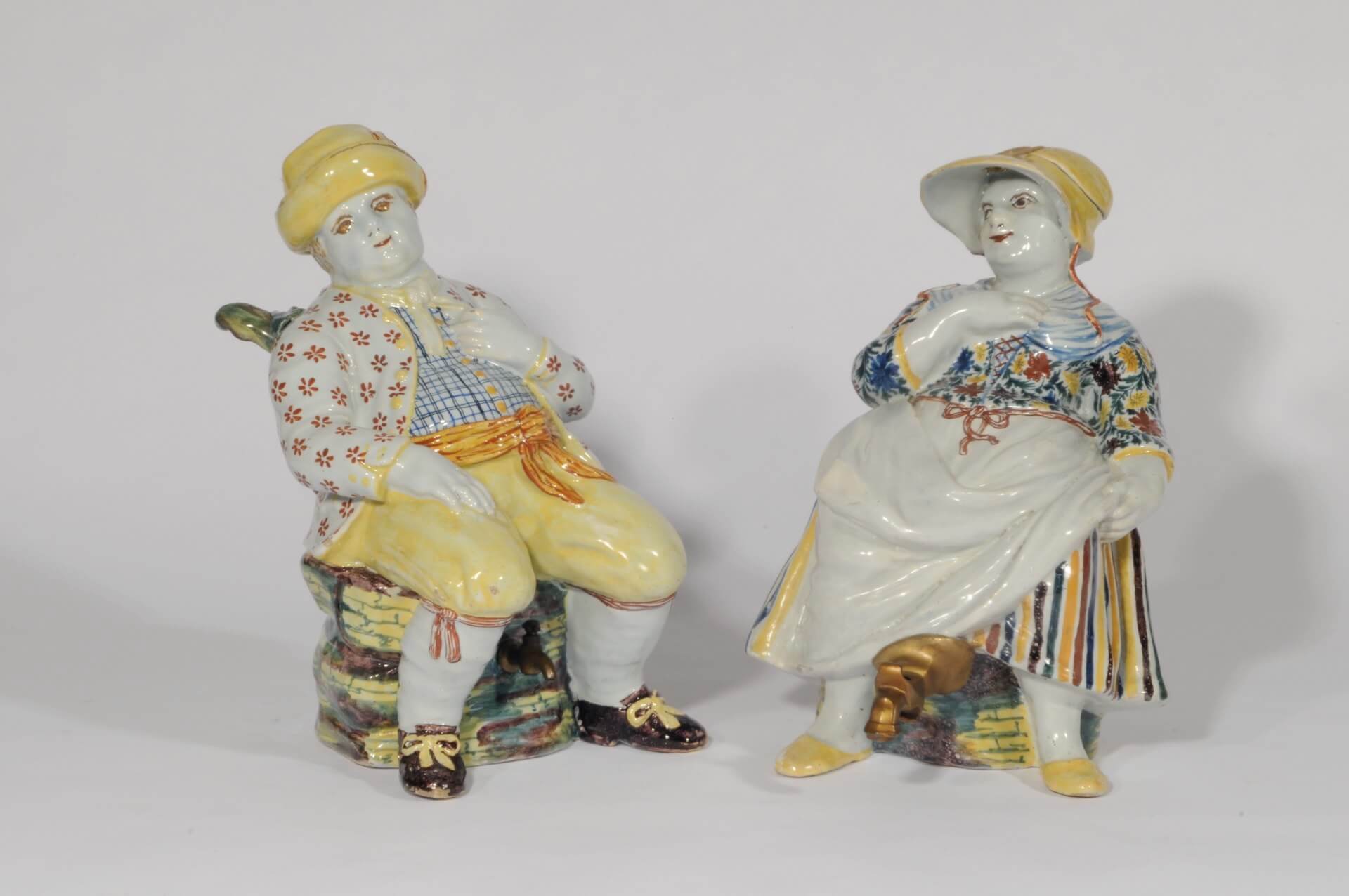 Antique Delft pottery duo of polychrome man and woman