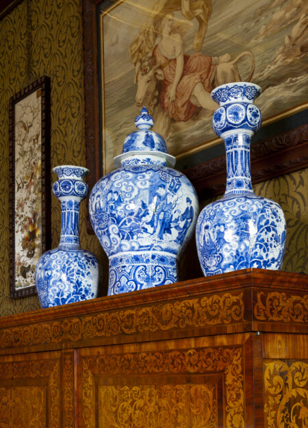 Garniture of three blue-and-white baluster Delft vases, painted with figures in the Chinese Transitional style