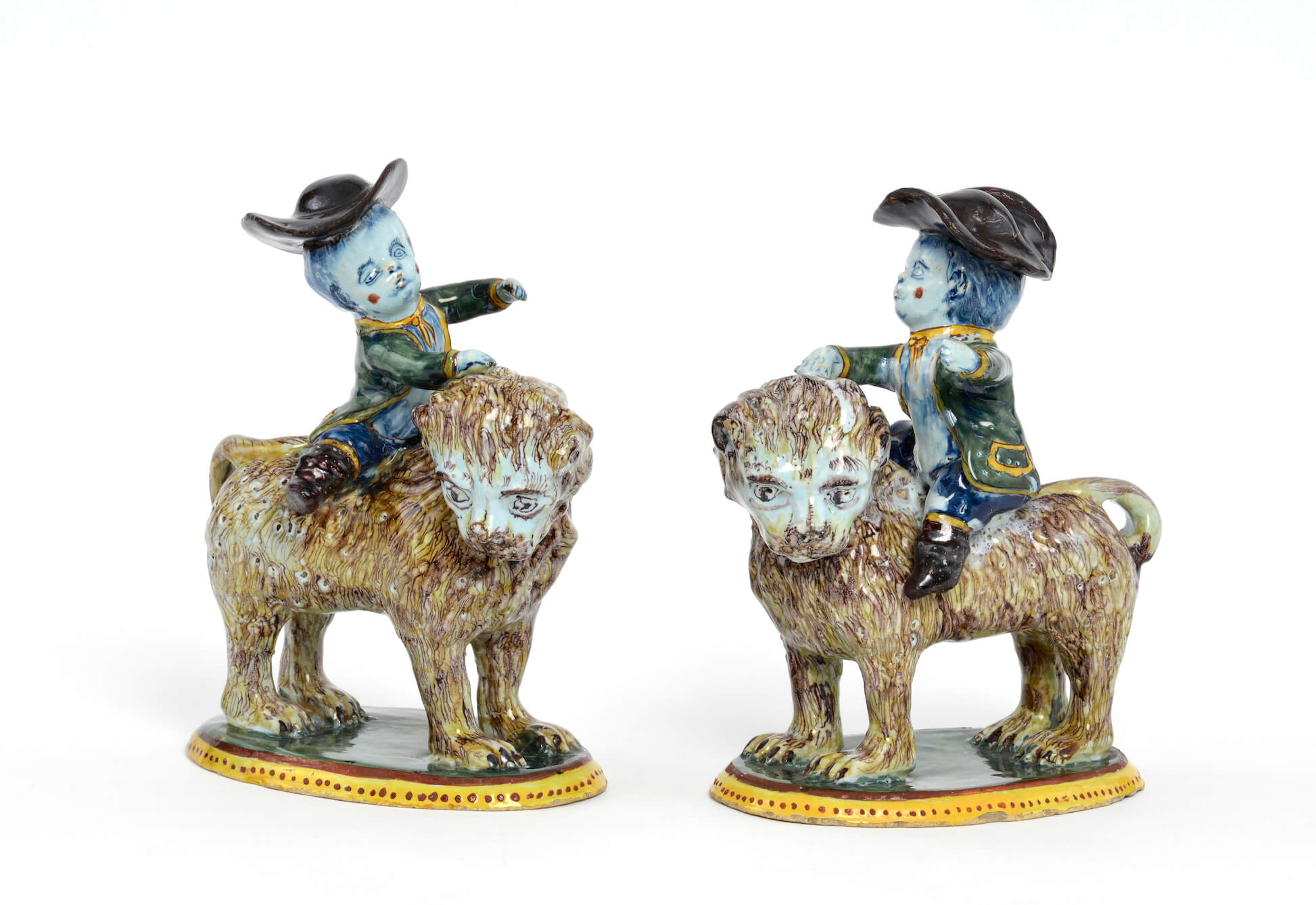 Antique polychrome figurine of boys riding lions at Aronson Antiquairs