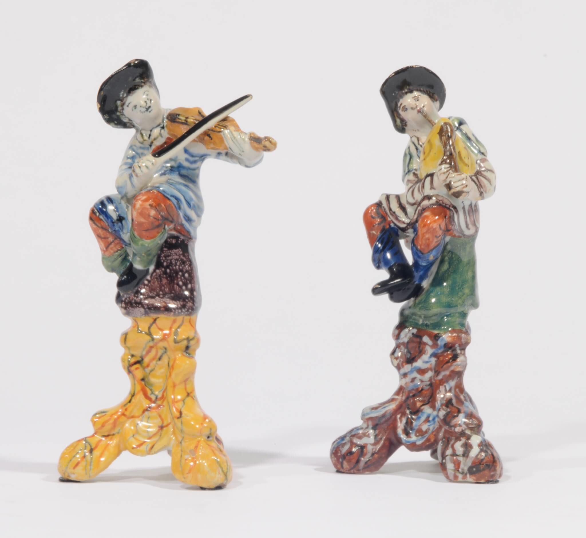 D.0927 Two Polychrome Figures of Musicians: a Violinist and a Bagpiper antique earthenware