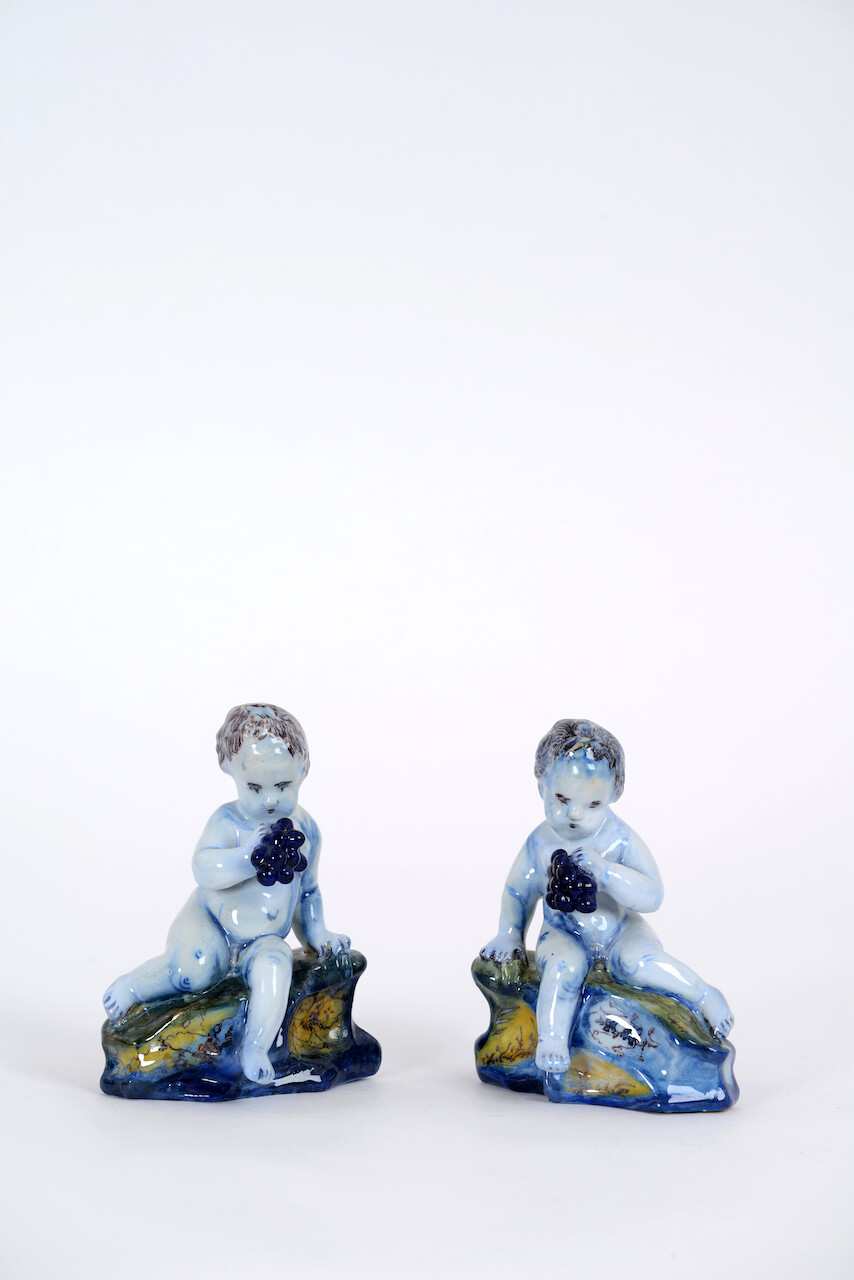 1940. Pair of Polychrome Figures of Seated Putti with Grapes