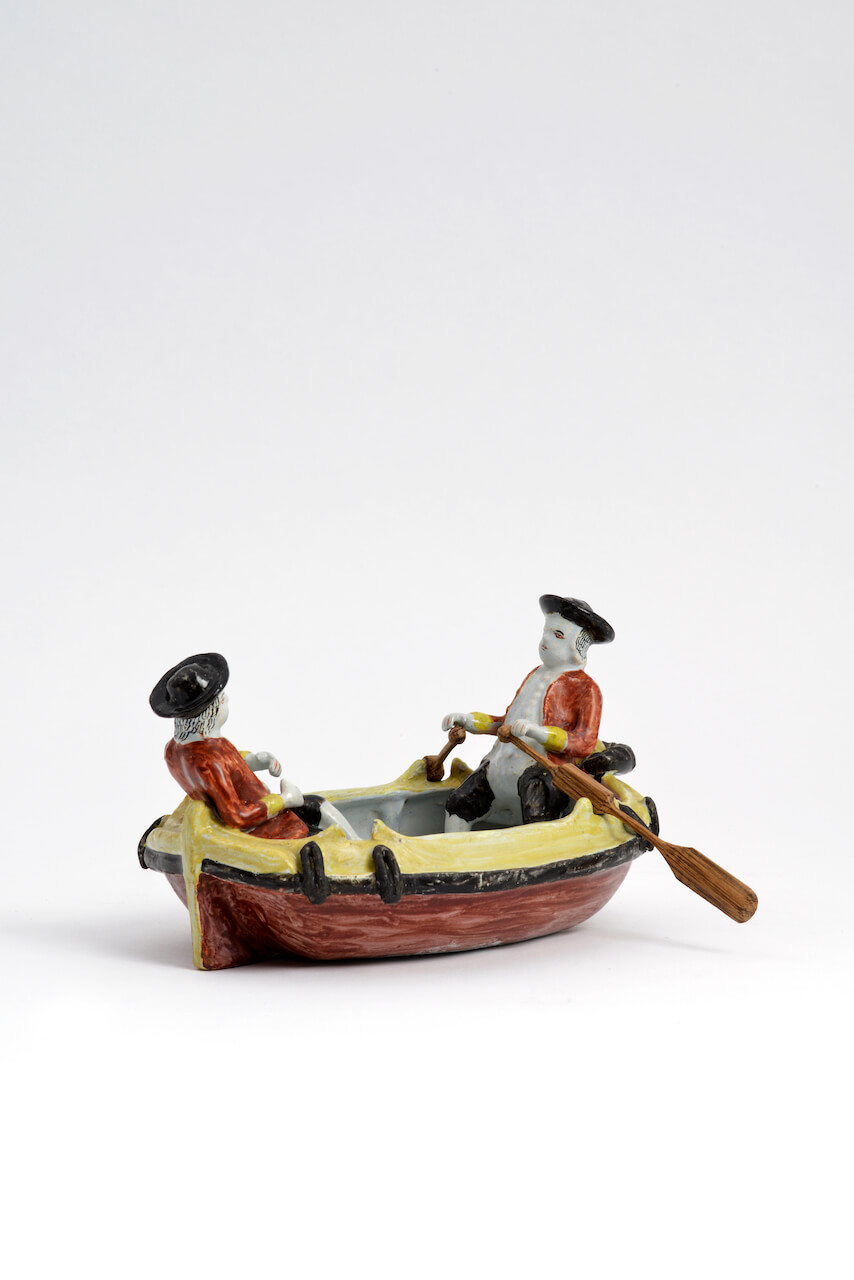 D1976. Polychrome Group of Two Gentlemen in a Boat