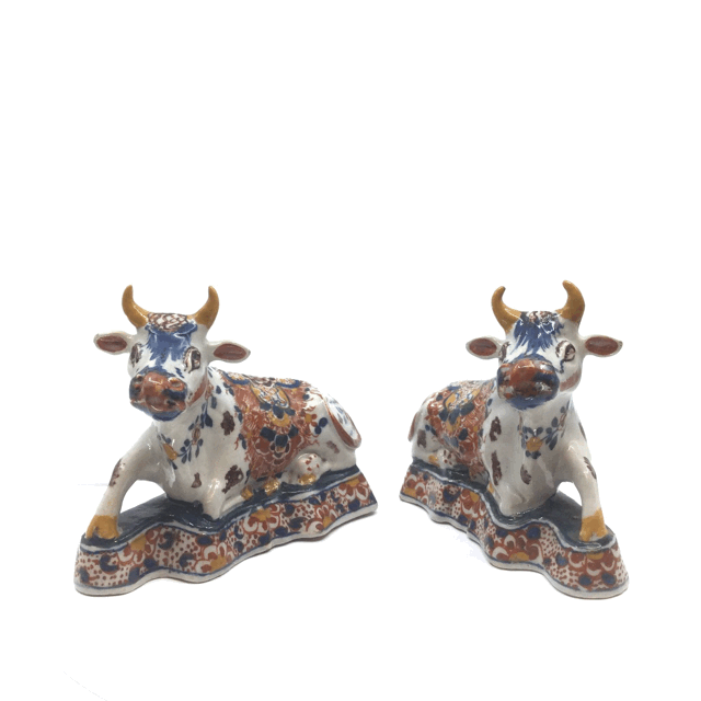 Pair of polychrome figures of recumbent cows