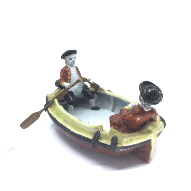 Polychrome group of two gentlemen in a boat