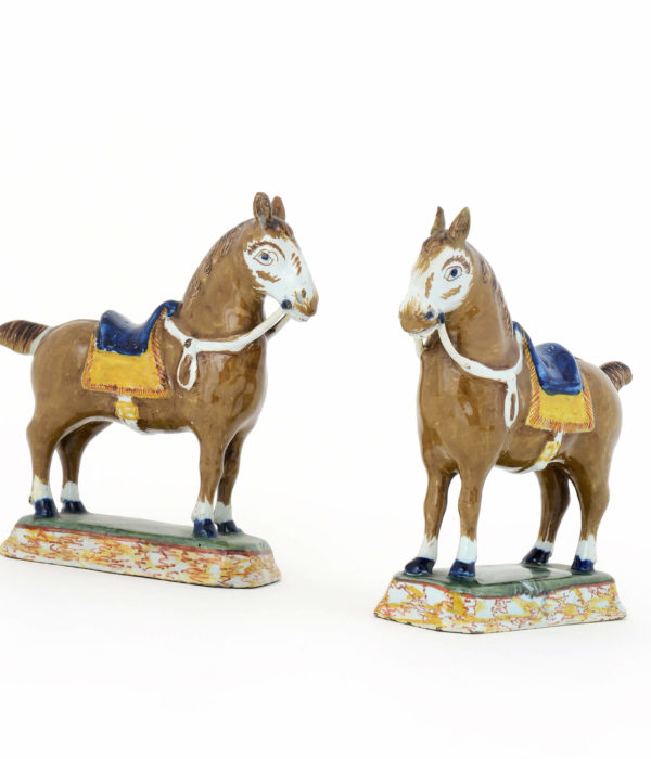 Pair of polychrome Delftware figures of horses