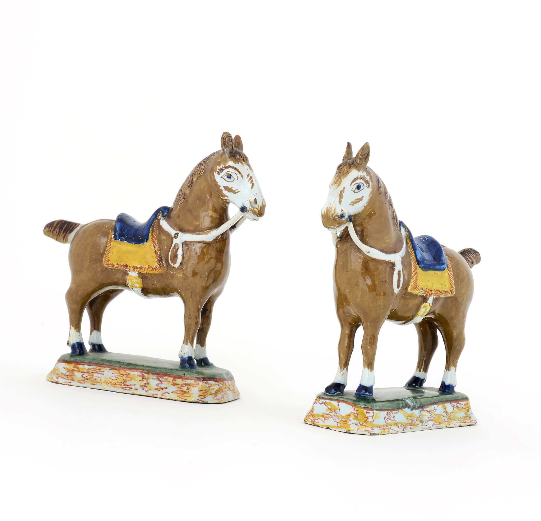 Pair of polychrome Delftware figures of horses
