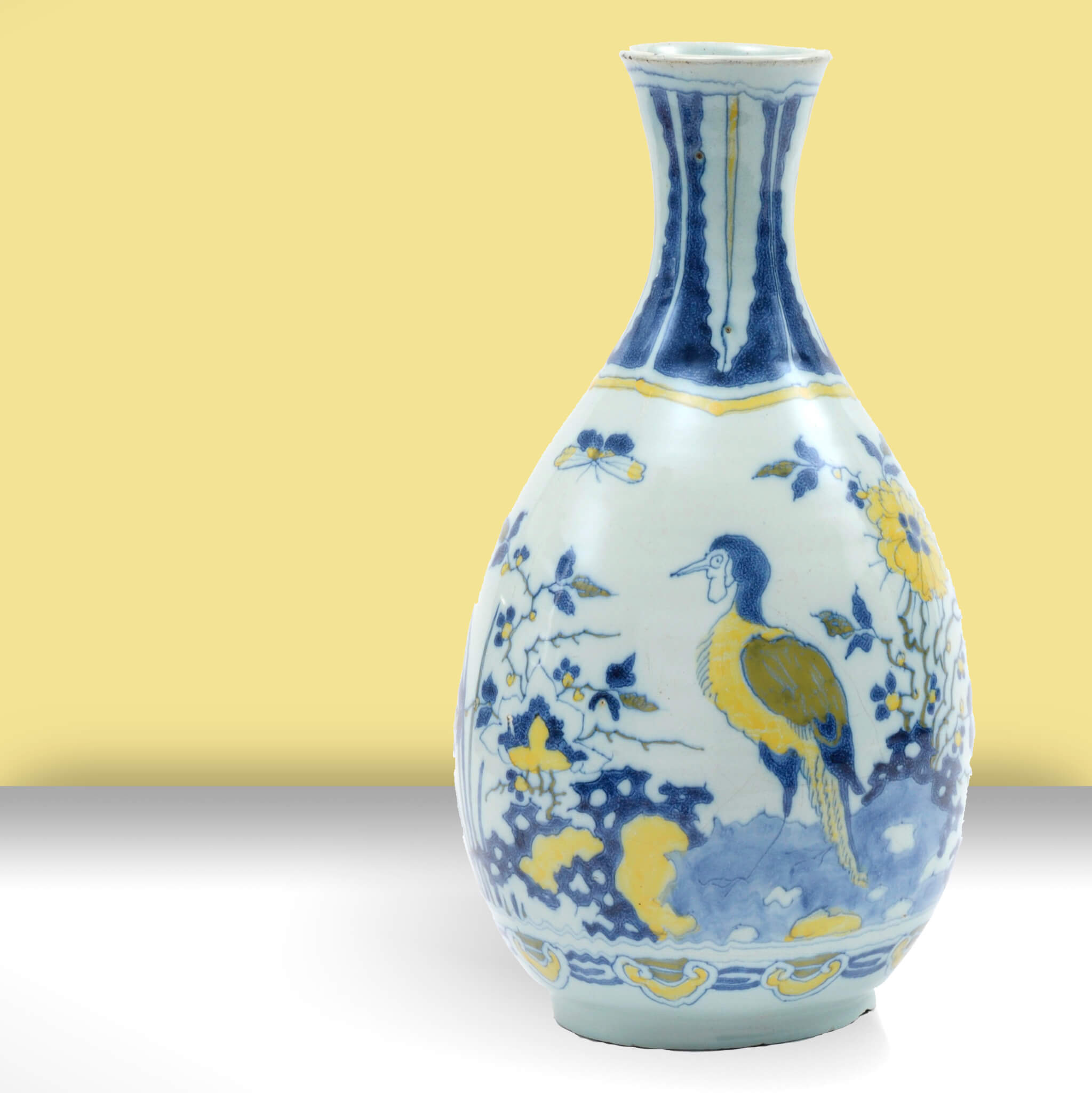 Delftware vase on yellow background