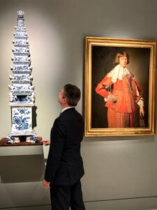 Robert Aronson inspects Delftware vase