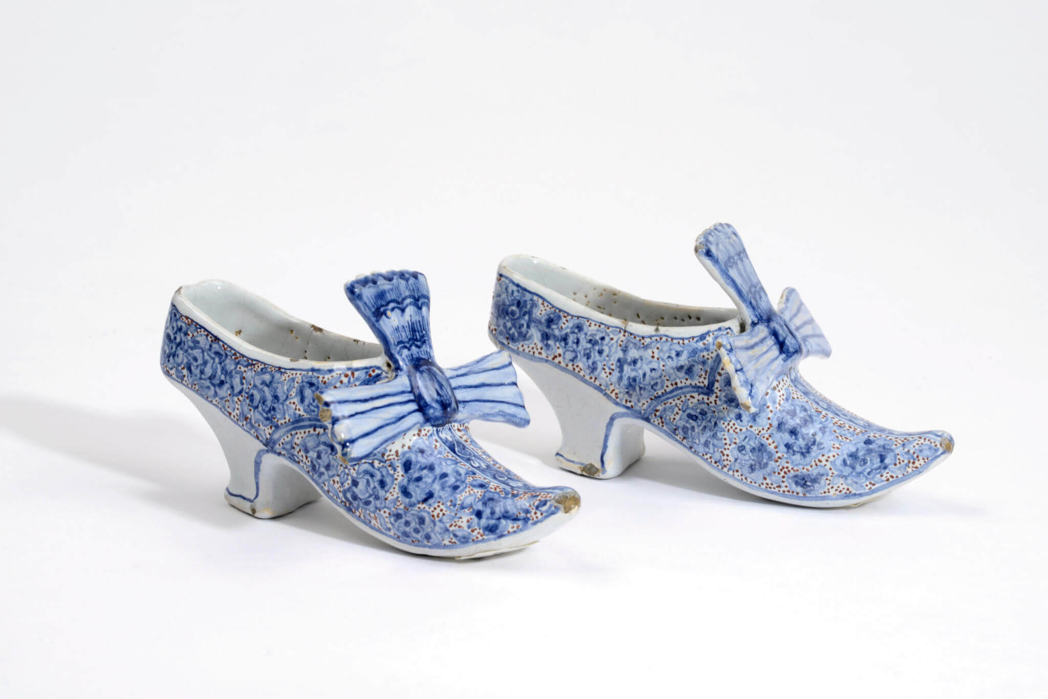 Delftware polychrome models of shoes bows