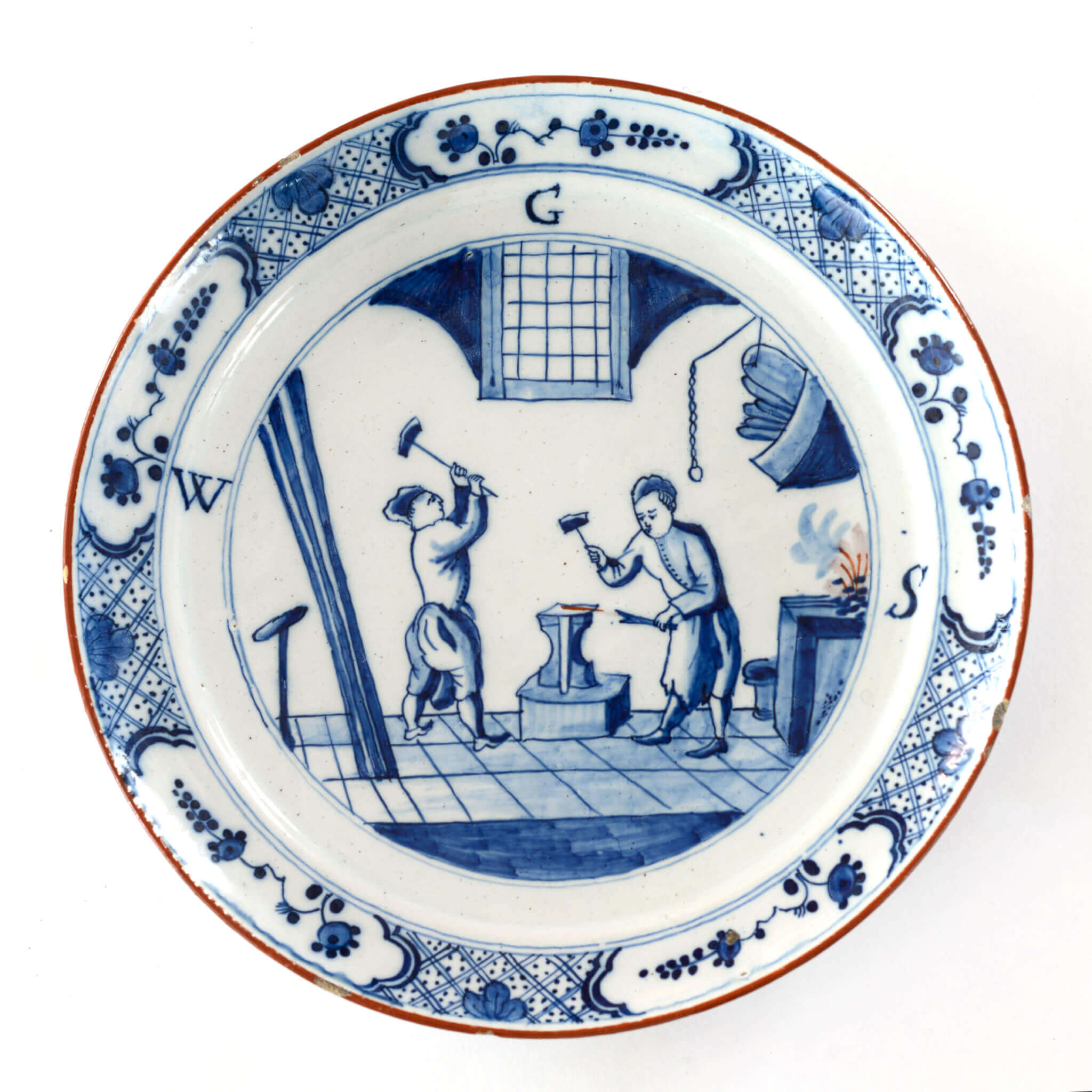 2069 Blue and white Delftware plate men in smithy