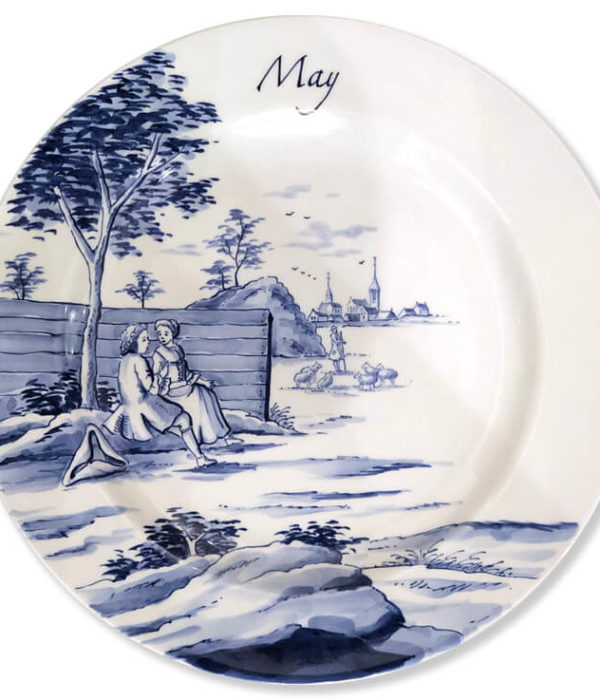 Blue and white modern Delftware plate with a pair of sweethearts seated beneath a tree with a shepherd tending his flock in the distance