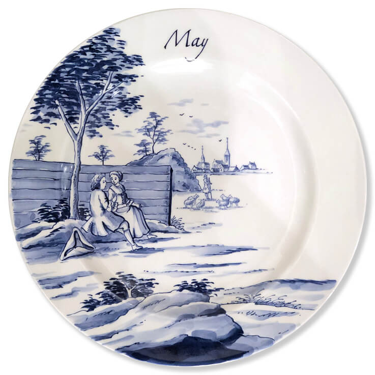 Blue and white modern Delftware plate with a pair of sweethearts seated beneath a tree with a shepherd tending his flock in the distance