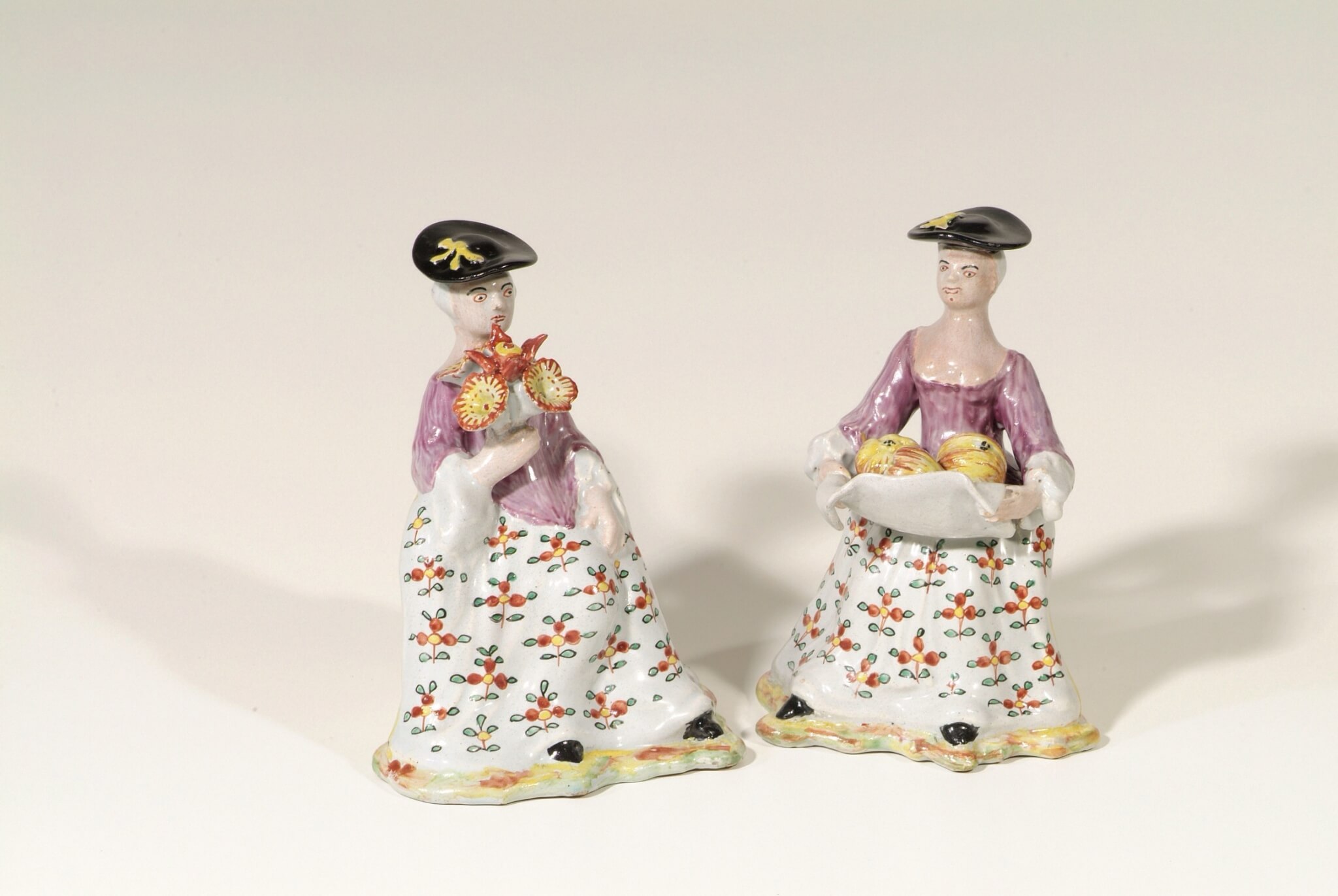 D667. Pair of Polychrome Figures of Seated Ladies